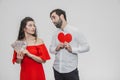 Money and love. Dollar hands. A man holds a red heart in his arms a wife holds the money. Valentine`s Day Royalty Free Stock Photo