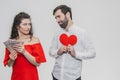 Money and love. Dollar hands. A man holds a red heart in his arms a wife holds the money. Valentine`s Day Royalty Free Stock Photo