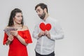 Money and love. Dollar hands. A man holds a red heart in his arms a wife holds the money. Valentine`s Day Royalty Free Stock Photo