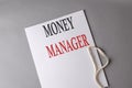 MONEY MANAGER text on white folder on grey background Royalty Free Stock Photo