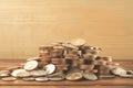 Money matters Coins neatly stacked on a wooden table