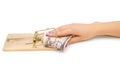 Money in mousetrap with hand. Royalty Free Stock Photo