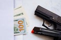 Money for murder. Black gun on American dollars background. Military industry, war, global arms trade, weapon sale, contract Royalty Free Stock Photo