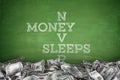 Money never sleeps on blackboard background