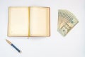 Money, notebook and pen with white background. Isolated Royalty Free Stock Photo