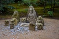 Money offered to statues in garden of Golden Pavilion in Kyoto Royalty Free Stock Photo