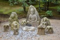 Money offered to statues in garden of Golden Pavilion in Kyoto Royalty Free Stock Photo