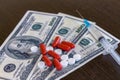 Money and pills with drugs and a syringe on the medical table Royalty Free Stock Photo