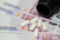 Money pills. Medicine pills on euro bills white medicine tablets on money. Covid-19 coronavirus pills are in euro money