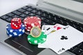 Money, playing cards, dice and casino chips on computer keyboard Royalty Free Stock Photo