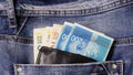 Money in the pocket of jeans. Colorful Israeli shekel in a leather wallet Royalty Free Stock Photo