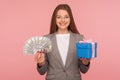 Money for present, shopping bonus. Portrait of happy elegant businesswoman in suit jacket holding gift box Royalty Free Stock Photo