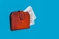 Money in a red purse on a blue background Royalty Free Stock Photo