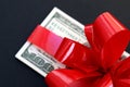 Money dollars wrapped in a bow on a gift Royalty Free Stock Photo