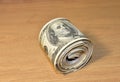 Money roll dollars on wooden table in office. Stack of money rolls 100 american hundred. Large bundle of US one hundred dollar