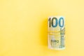 Money roll of euro banknotes yellow rubber band on yellow background Royalty Free Stock Photo