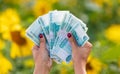 Money rubles in the hands of a girl in a field with sunflowers Royalty Free Stock Photo