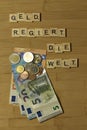 Money rules the world, word in german Geld regiert die Welt