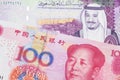 Money from Saudi Arabia close up in macro with a five yuan note from China