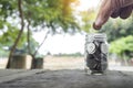 Money save tax income. businessman holding coins putting in glass on green nature background. Concept money save income Royalty Free Stock Photo