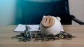 money saving concept. pile of coins, piggy bank and account book on desk background, long term investment for retirement. Interest Royalty Free Stock Photo