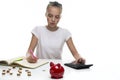 Money Saving Concepts. Teenager Blond Girl Posing With Coins and Moneybox. Calculating Income With Calculator For Savings. Focus Royalty Free Stock Photo
