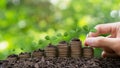 Money-saving,Growing Money,Finance And Investment concept.Hand putting plants growing up on stack coins.Business growth, Royalty Free Stock Photo