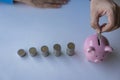 Money saving ideas for future accounting planning. Male hand putting coins in piggy bank Money plans Royalty Free Stock Photo