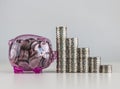 Money savings, business growth or financial concept. A pink piggy bank and stack of coins on white background Royalty Free Stock Photo