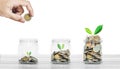 Money savings and business investment concept, bottle of coins on white wood on white background Royalty Free Stock Photo