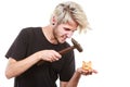 Sreaming man trying break piggy bank with hammer