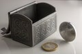 Money in the shiny silver box on the table. Euro coin stocks from different countries Royalty Free Stock Photo