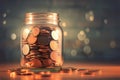 Money stash Glass jar filled with coins, blurred background, saving