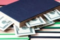Money sticking out of the book lying on the rows of books Royalty Free Stock Photo
