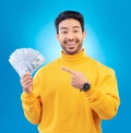 Money, studio portrait and happy man point at dollar bills, competition reward or bonus salary prize. Savings pay, cash Royalty Free Stock Photo