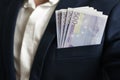 Money success concept. 500 euro bills in businessman jacket pocket. Symbol of success and wealth