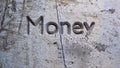 MONEY TALKS word carved in stone wall