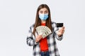 Money transfer, investment, covid-19 pandemic and working from home concept. Surprised young woman showing credit card