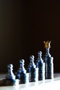 Money is a true king. Chess pawn stand on the highest coin stack wearing a crown. Wealthiness concept Royalty Free Stock Photo