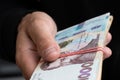 Money of Ukraine. Stack of ukrainian hryvnia banknotes in hands. Hryvnia 1000 uah