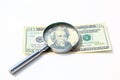 money under magnify glass isolated