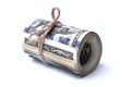 Money US dollars in a roll tied with a rope on a white isolated background Royalty Free Stock Photo