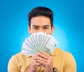 Money, winner and man cover face isolated on blue, studio background for winning, cash fan or financial loan. Lottery Royalty Free Stock Photo