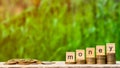 `money` word on stack of coins and a pile of golden coins on wooden table. Royalty Free Stock Photo