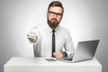 Money are yours! Portrait of handsome richman bearded young big boss in white shirt and black tie are sitting in office giving Royalty Free Stock Photo