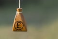 Moneybag with a pound sign on a blurred background. Financial stability in business