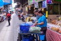 Monger and merchant selling traditional food at market in Sam Chuk District, Suphan Buri, Thailand