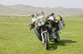 Travel motobike with equipment jn green field of Mongolia.