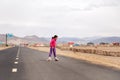 Mongolia Ulgii 2019-05-05 Mongolian boy in colorful clothes rides pink inline skates on road in asian village on