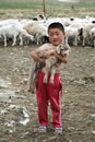 Mongolian Boy holding Baby Goat Royalty Free Stock Photo